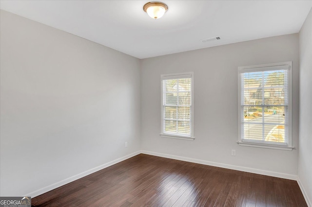 spare room with dark hardwood / wood-style floors