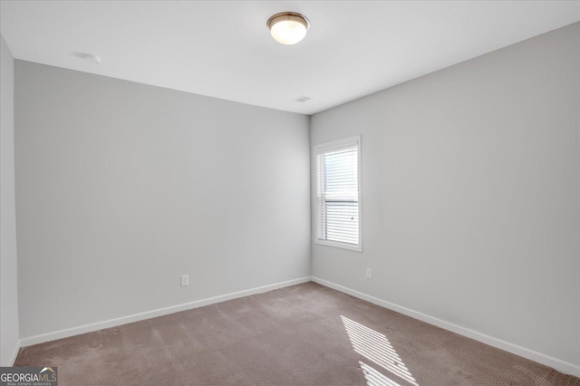 unfurnished room with light colored carpet