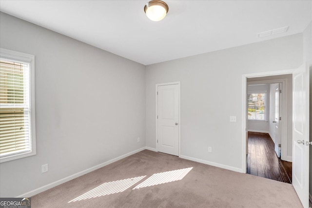 empty room with dark carpet