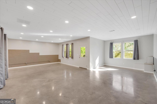 unfurnished living room with concrete floors