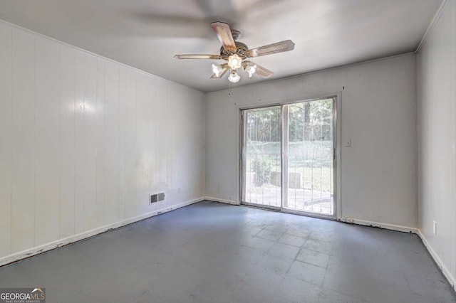 spare room with ceiling fan, wooden walls, and ornamental molding