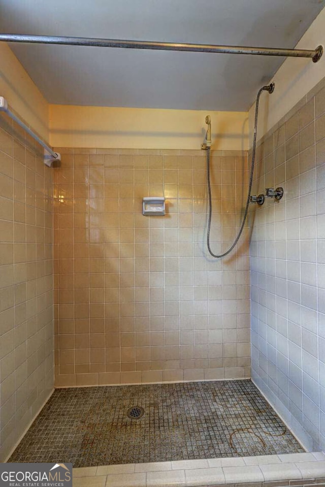 bathroom with tiled shower