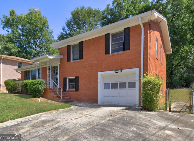 split level home with a garage and a front lawn