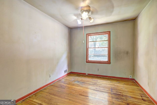 spare room featuring ceiling fan and light hardwood / wood-style flooring