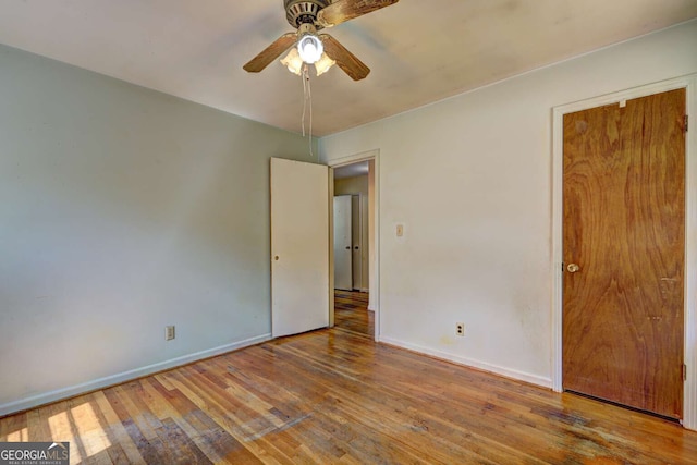 unfurnished bedroom with ceiling fan and hardwood / wood-style flooring