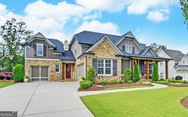 craftsman inspired home featuring a garage and a front lawn