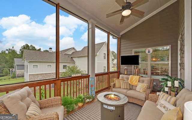 sunroom / solarium with ceiling fan and lofted ceiling