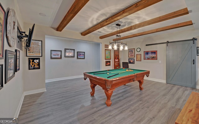 game room with a barn door, hardwood / wood-style floors, beamed ceiling, and billiards