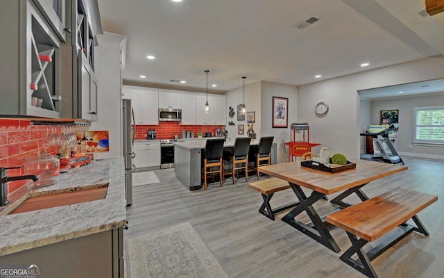 dining area featuring light hardwood / wood-style floors and sink