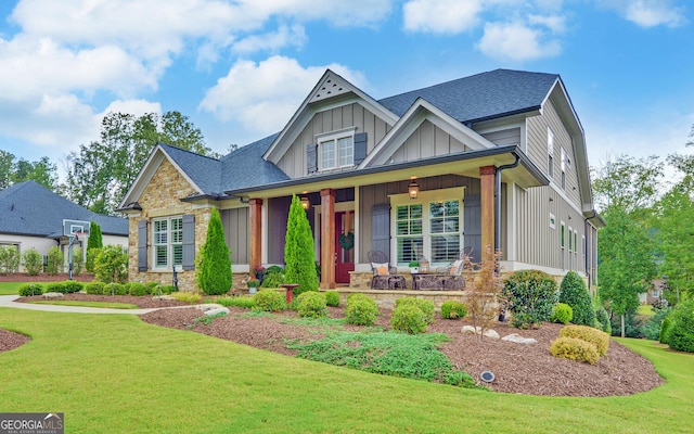 craftsman-style house featuring a porch and a front lawn