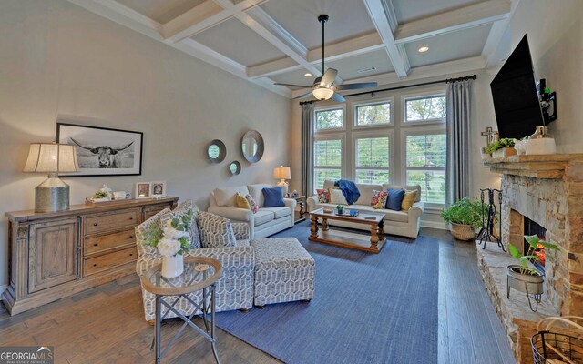 living room featuring a fireplace, coffered ceiling, ceiling fan, hardwood / wood-style flooring, and beamed ceiling