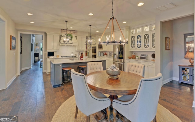 dining space with dark hardwood / wood-style floors