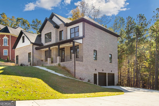 view of front facade featuring a front yard, a porch, and a garage