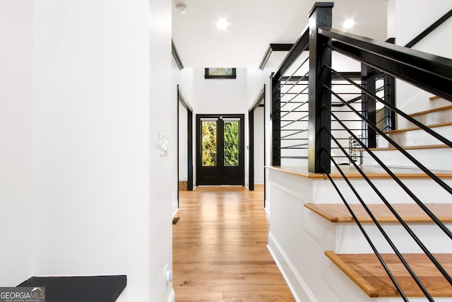 hallway featuring french doors and light hardwood / wood-style floors