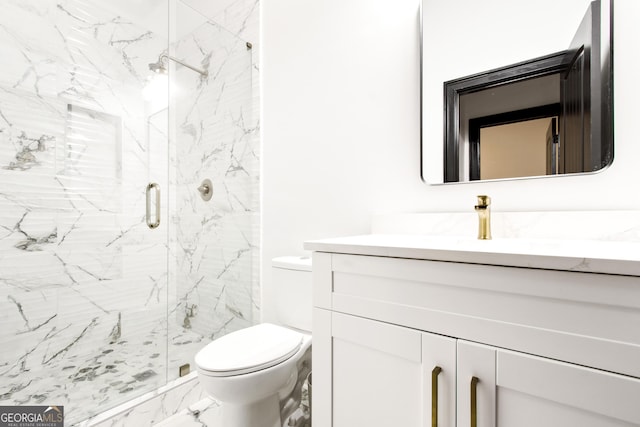 bathroom with a shower with door, vanity, and toilet