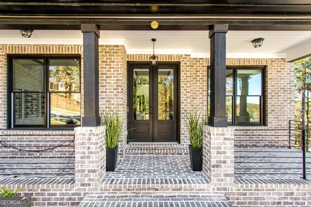 property entrance featuring french doors and covered porch