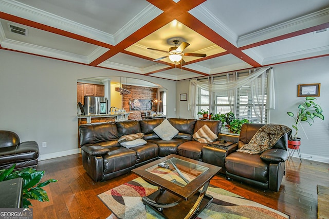 living room with dark hardwood / wood-style floors, ceiling fan, ornamental molding, and coffered ceiling