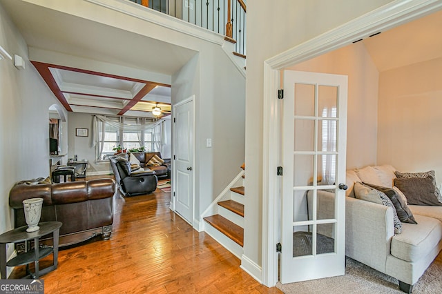 interior space with hardwood / wood-style flooring, ceiling fan, beamed ceiling, and coffered ceiling