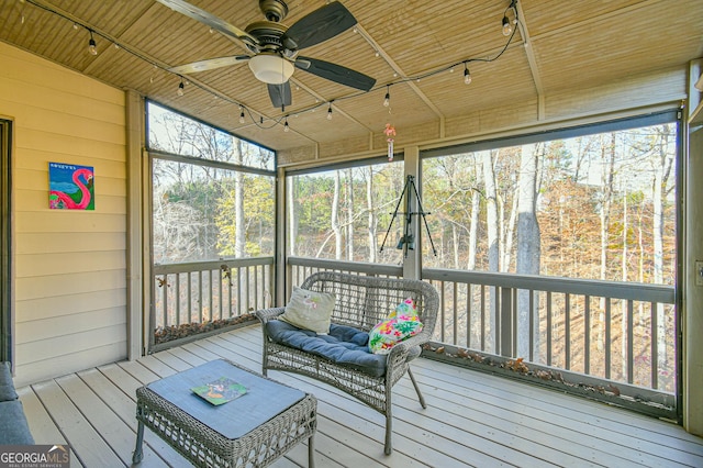 sunroom featuring ceiling fan, wooden ceiling, and vaulted ceiling