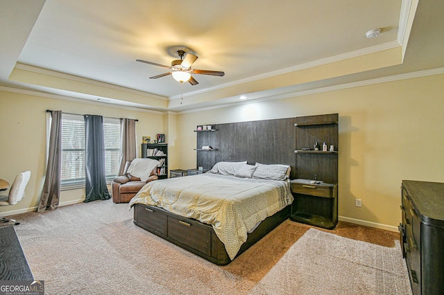 bedroom featuring a tray ceiling, ceiling fan, and crown molding