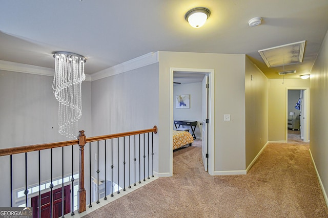 corridor featuring light carpet, an inviting chandelier, and crown molding