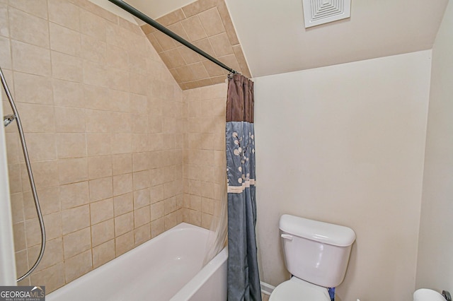 bathroom featuring toilet, shower / bath combo with shower curtain, and vaulted ceiling