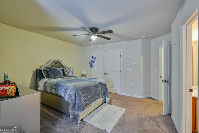 carpeted bedroom with ceiling fan and a closet