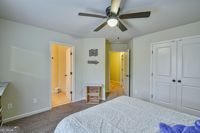 carpeted bedroom featuring ceiling fan, a closet, and ensuite bathroom