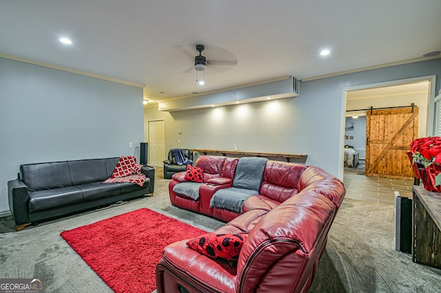 living room featuring a barn door, ceiling fan, light colored carpet, and ornamental molding