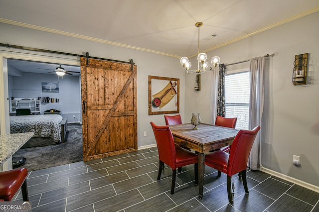 dining room featuring ceiling fan with notable chandelier, a barn door, and crown molding