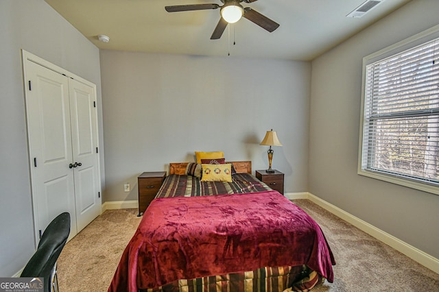 carpeted bedroom with a closet and ceiling fan