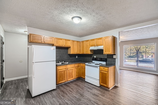 kitchen with white appliances, sink, dark hardwood / wood-style floors, a textured ceiling, and tasteful backsplash