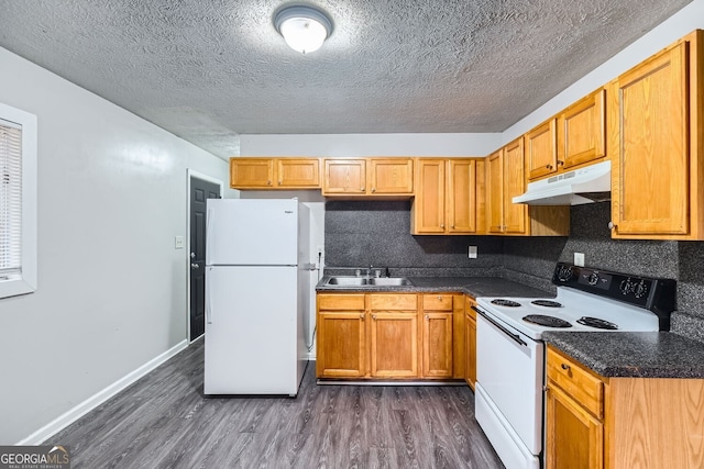 kitchen featuring a textured ceiling, sink, dark hardwood / wood-style floors, and white appliances