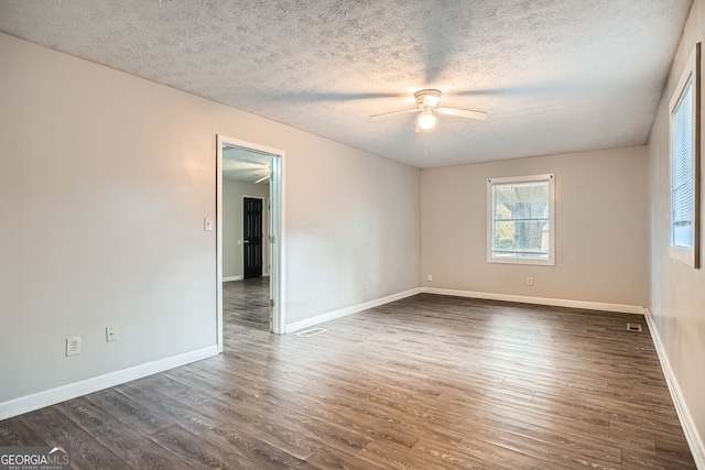 unfurnished room featuring ceiling fan, dark hardwood / wood-style flooring, and a textured ceiling