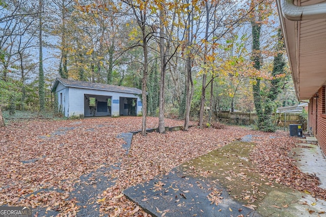 view of yard with cooling unit and an outdoor structure