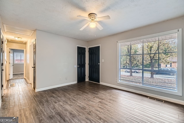 empty room featuring hardwood / wood-style floors, a textured ceiling, and ceiling fan