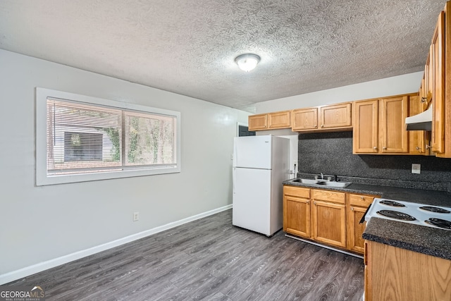 kitchen featuring a textured ceiling, dark hardwood / wood-style flooring, white appliances, and sink