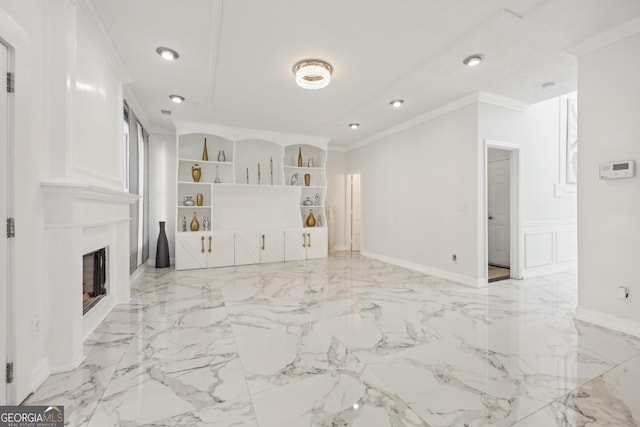 unfurnished living room featuring built in shelves and ornamental molding