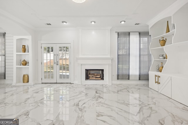 unfurnished living room with french doors, built in features, and crown molding