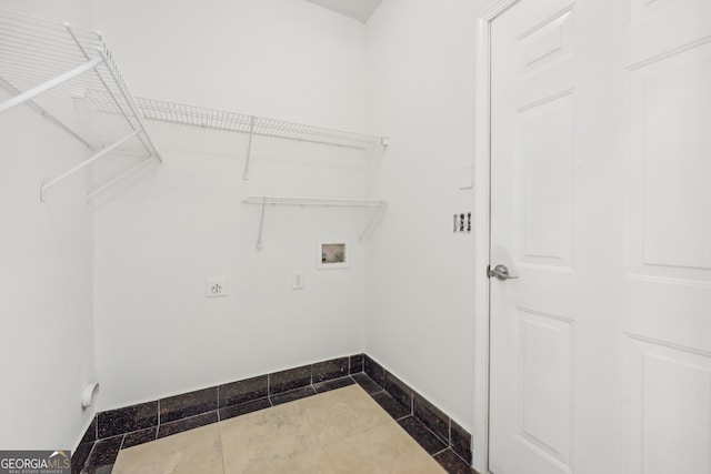 laundry area with electric dryer hookup, tile patterned flooring, and washer hookup