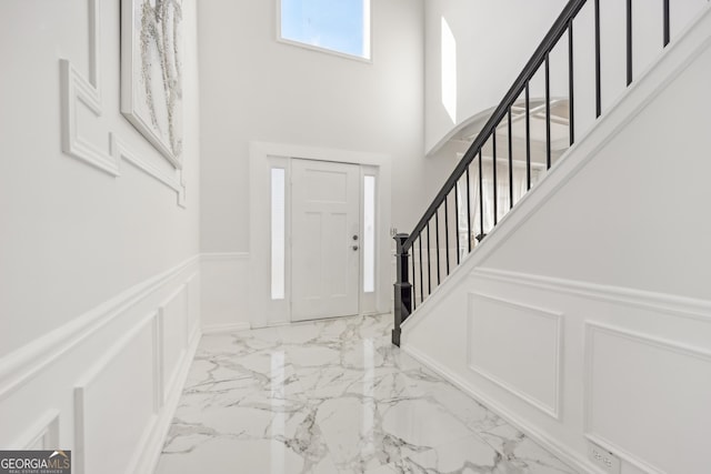 entryway with a towering ceiling