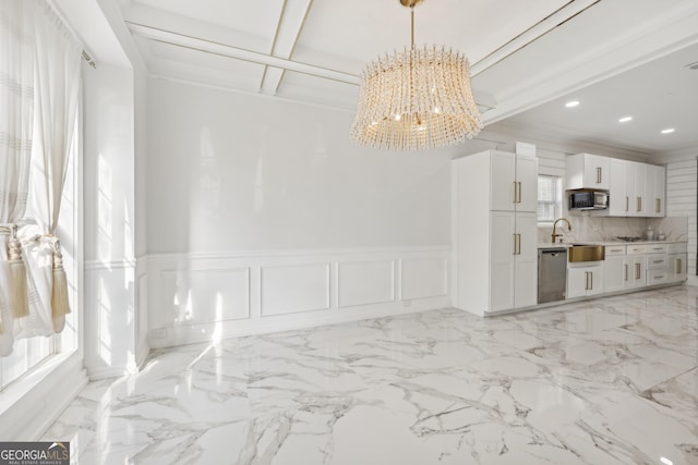 living room featuring a chandelier, beam ceiling, a healthy amount of sunlight, and sink