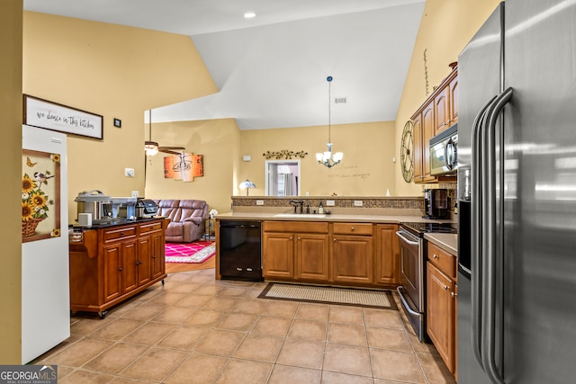 kitchen featuring kitchen peninsula, appliances with stainless steel finishes, hanging light fixtures, and sink