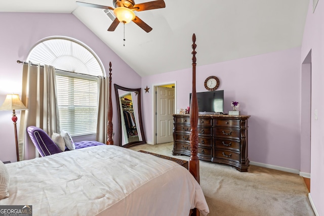 bedroom with a closet, light colored carpet, vaulted ceiling, and ceiling fan