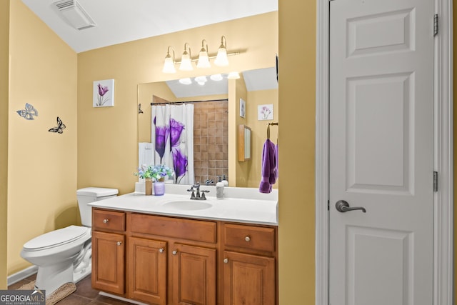 bathroom featuring a shower with shower curtain, vanity, toilet, and tile patterned floors