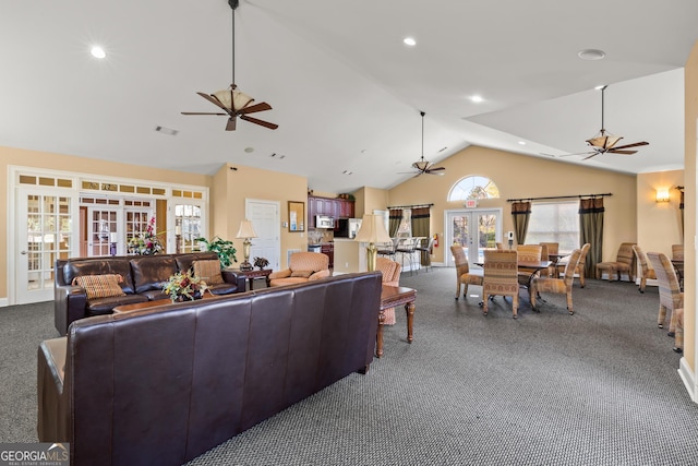 carpeted living room featuring vaulted ceiling and french doors