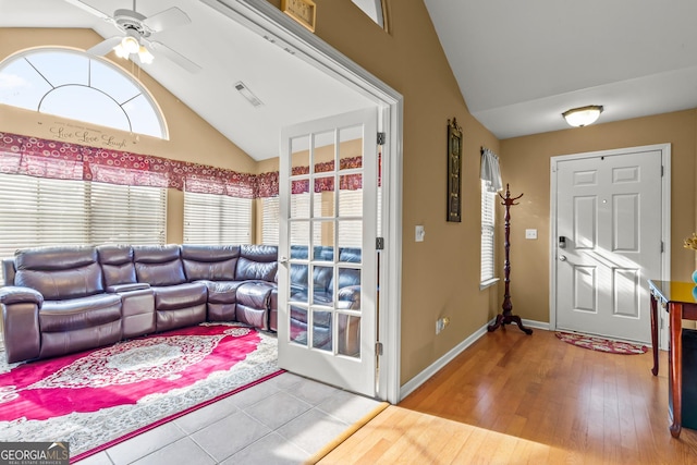 living room featuring hardwood / wood-style flooring, vaulted ceiling, and ceiling fan