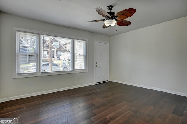 unfurnished room with plenty of natural light, ceiling fan, and dark wood-type flooring