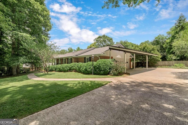 view of side of property featuring a yard and a carport