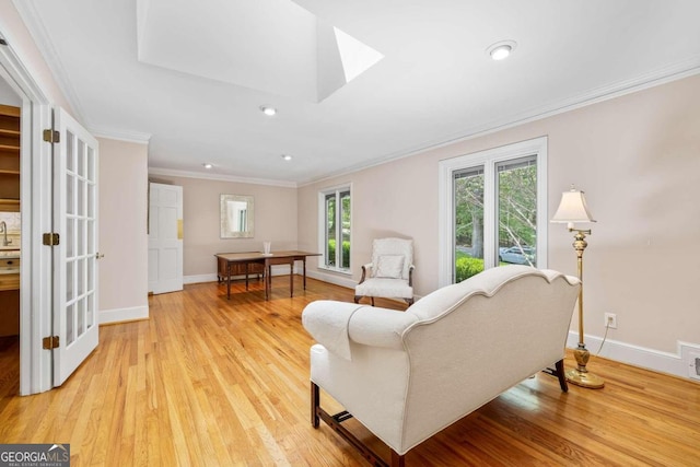 living room featuring light wood-type flooring and ornamental molding